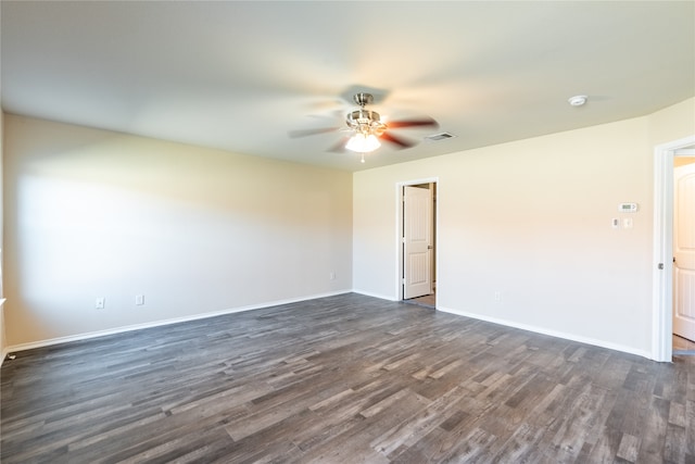 empty room featuring ceiling fan and dark hardwood / wood-style floors