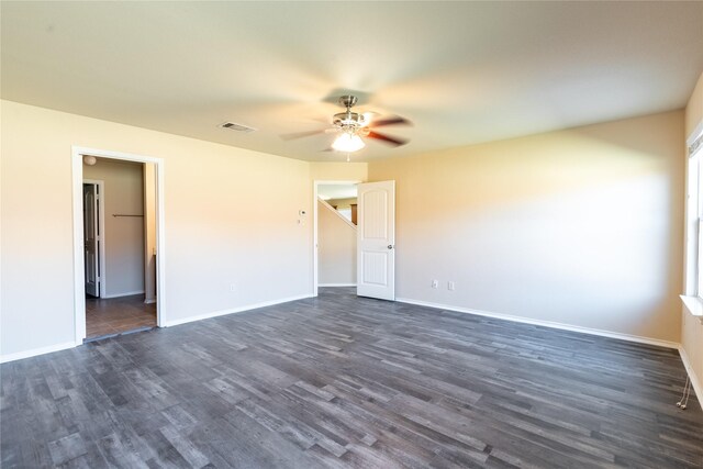 unfurnished room with dark hardwood / wood-style flooring and ceiling fan