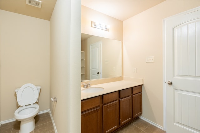 bathroom with tile patterned floors, vanity, and toilet