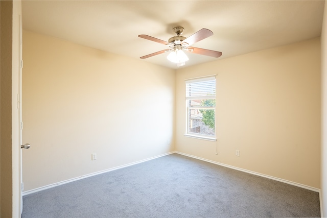 empty room featuring carpet flooring and ceiling fan