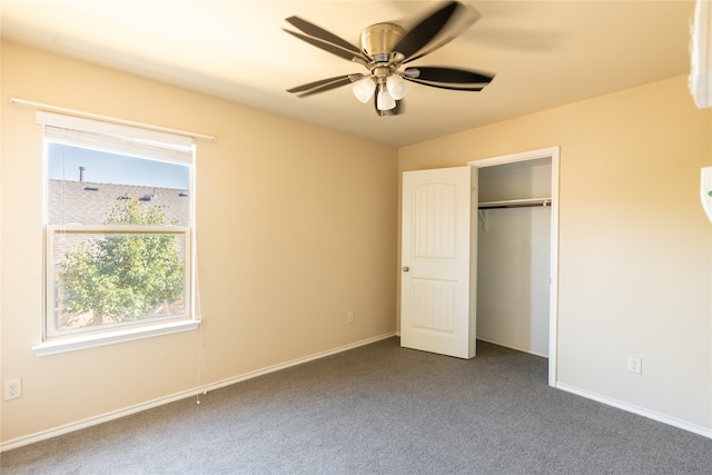 unfurnished bedroom with ceiling fan, a closet, and dark carpet