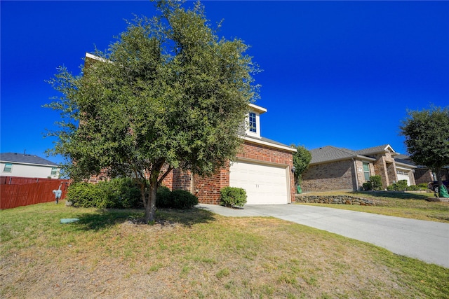 view of front of property featuring a front lawn and a garage