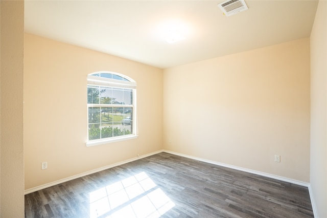 spare room with dark hardwood / wood-style floors