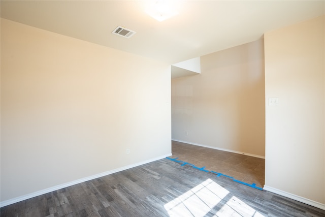 spare room featuring dark hardwood / wood-style floors