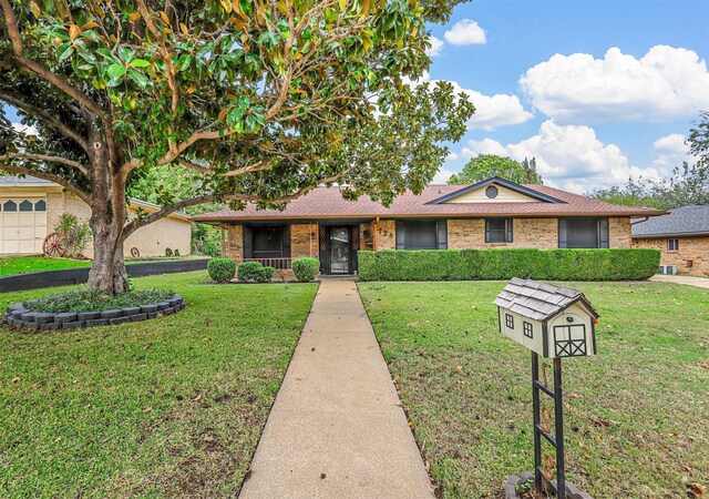 ranch-style home with a front yard