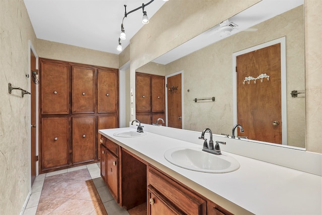 bathroom with tile patterned flooring, vanity, and ceiling fan