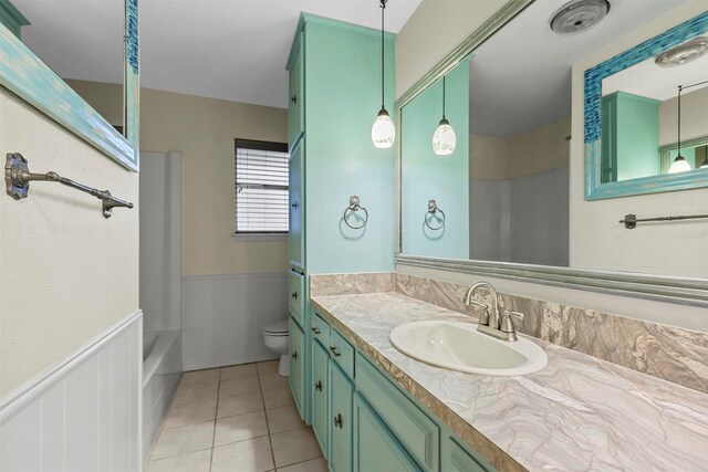 bathroom with tile patterned floors, vanity, and toilet