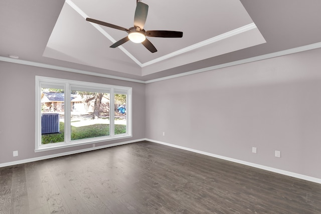 empty room with ceiling fan, dark hardwood / wood-style flooring, ornamental molding, and vaulted ceiling