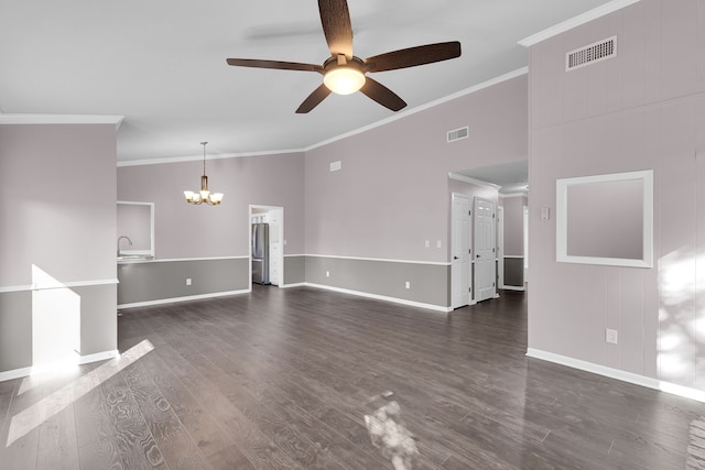 unfurnished living room with crown molding, a towering ceiling, dark wood-type flooring, and ceiling fan with notable chandelier