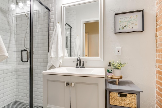 bathroom with vanity and a shower with shower door