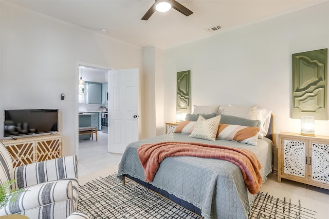 tiled bedroom with ornamental molding and ceiling fan