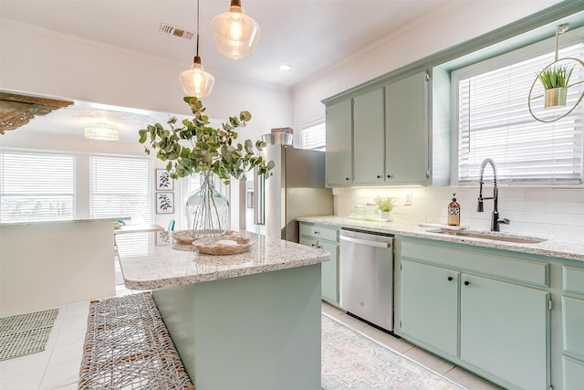 kitchen featuring appliances with stainless steel finishes, tasteful backsplash, sink, ornamental molding, and light stone countertops