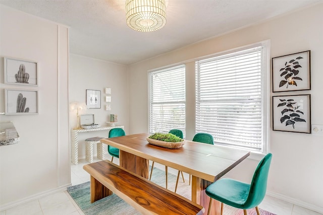 tiled dining space with a textured ceiling