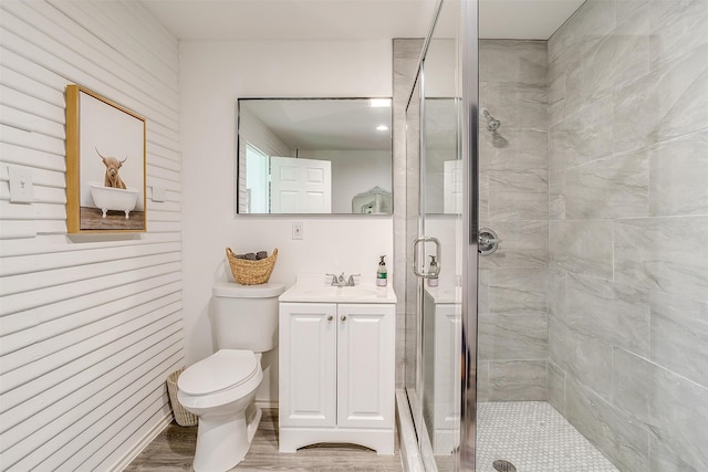 bathroom featuring walk in shower, vanity, toilet, and hardwood / wood-style flooring