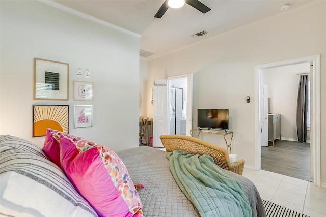 bedroom with crown molding, light tile patterned floors, ceiling fan, and ensuite bathroom