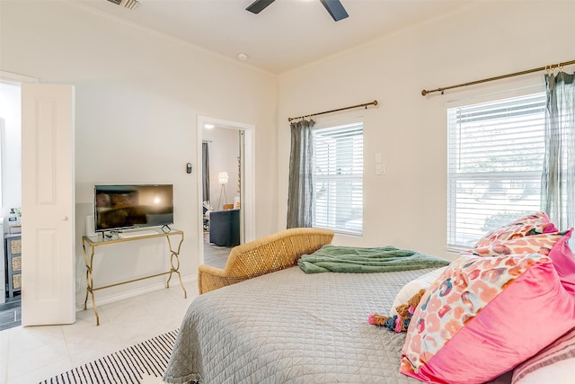 bedroom with ornamental molding, ceiling fan, and light tile patterned flooring