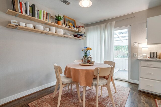 dining area featuring dark hardwood / wood-style flooring