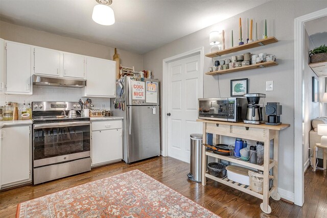 kitchen featuring hardwood / wood-style flooring, backsplash, white cabinetry, and stainless steel appliances