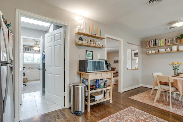 interior space featuring ceiling fan and dark wood-type flooring