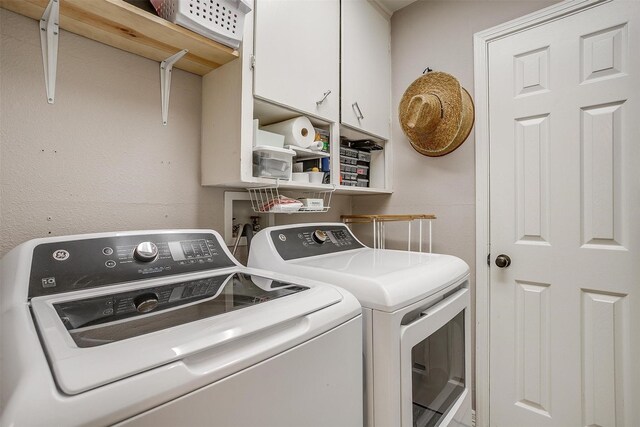 laundry area with cabinets and separate washer and dryer