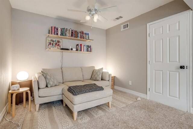 living room featuring ceiling fan and light colored carpet