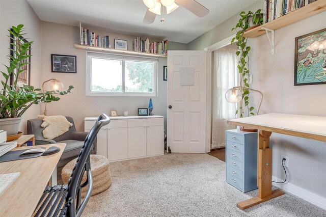 home office featuring light carpet and ceiling fan