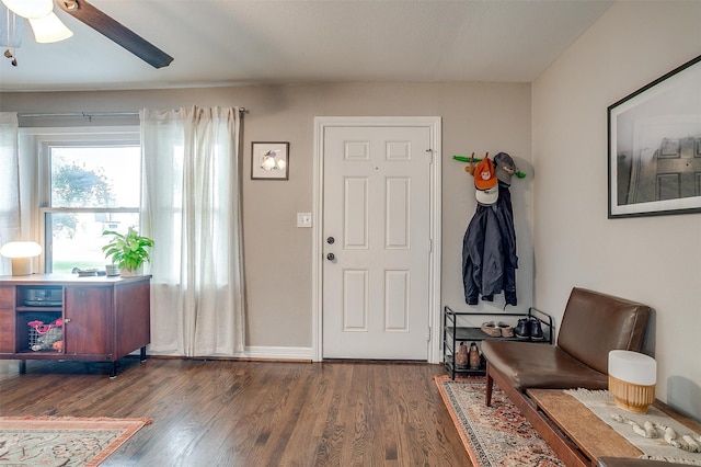 entryway with ceiling fan and dark wood-type flooring