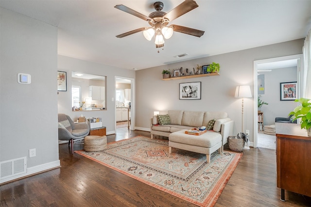 living room featuring dark hardwood / wood-style flooring and ceiling fan