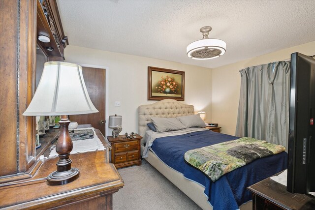 carpeted bedroom featuring a textured ceiling