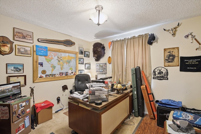 office area featuring a textured ceiling and carpet floors