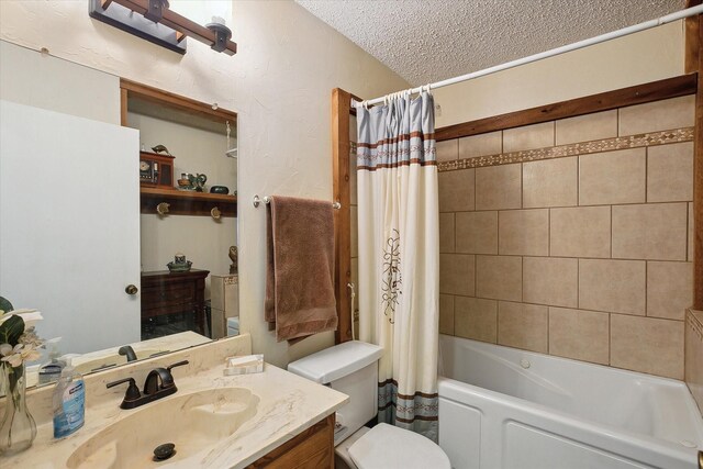 full bathroom featuring shower / tub combo with curtain, vanity, a textured ceiling, and toilet