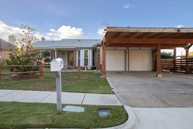 view of front of property with a carport and a front lawn