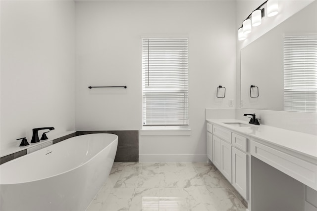 740 Wilderness Point Ln, Anna, TX 75409 - full bathroom featuring a soaking tub, marble look tiles, vanity, and healthy amount of natural light