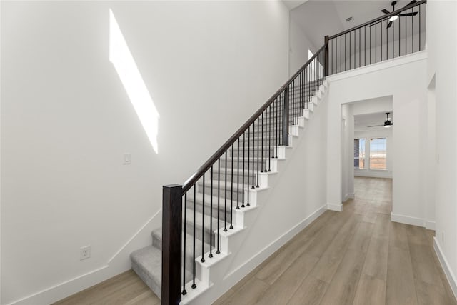 740 Wilderness Point Ln, Anna, TX 75409 - staircase with wood finished floors, a ceiling fan, and a high ceiling