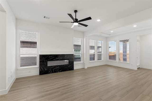 740 Wilderness Point Ln, Anna, TX 75409 - unfurnished living room with light wood finished floors, ceiling fan, a high end fireplace, and recessed lighting