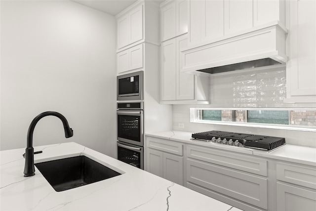 740 Wilderness Point Ln, Anna, TX 75409 - kitchen with stainless steel appliances, white cabinets, premium range hood, and light stone countertops