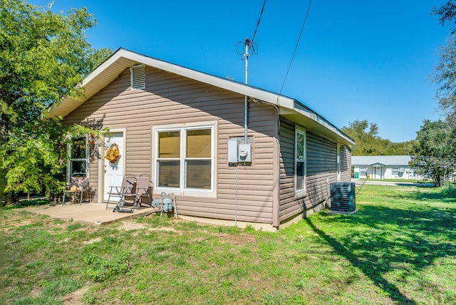 back of property featuring a patio, central AC, and a lawn