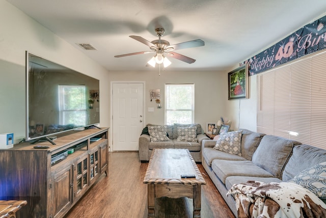 living room with wood-type flooring and ceiling fan