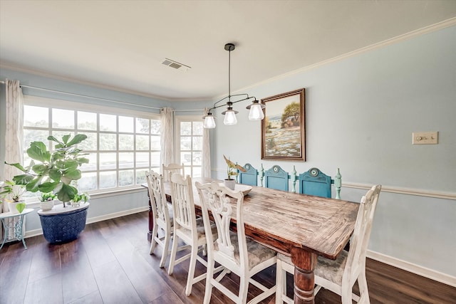 dining space featuring dark hardwood / wood-style floors and crown molding