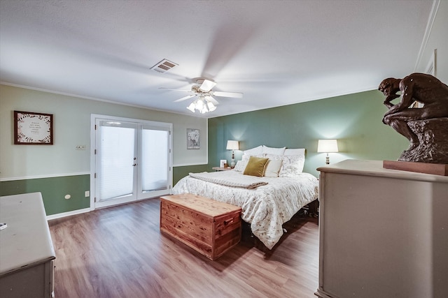 bedroom with access to exterior, hardwood / wood-style floors, ceiling fan, and ornamental molding