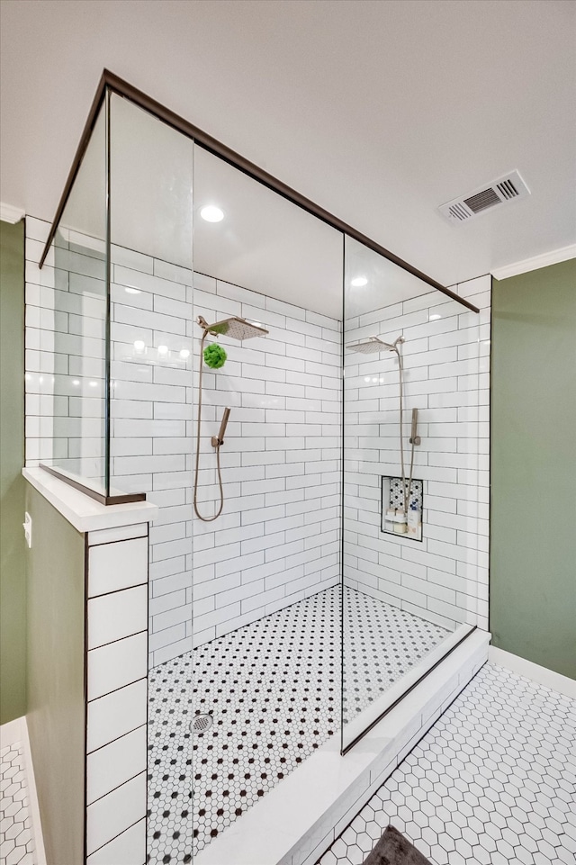 bathroom featuring tile patterned flooring and tiled shower