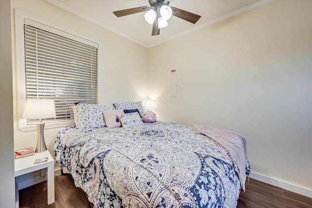 bedroom with ceiling fan, ornamental molding, and dark wood-type flooring