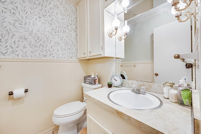 2225 W Park Ave, Corsicana, TX 75110 - bathroom with wallpapered walls, a wainscoted wall, toilet, and vanity