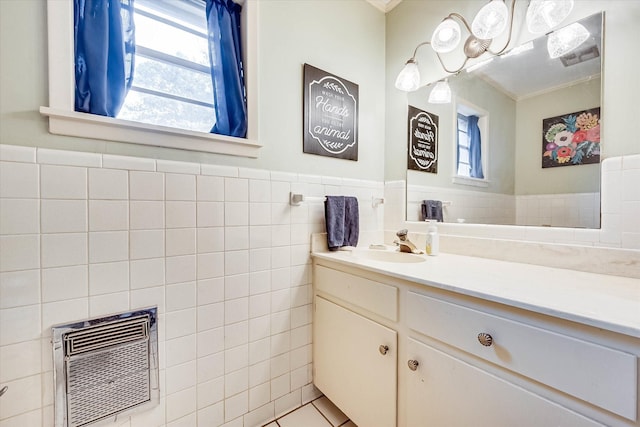 2225 W Park Ave, Corsicana, TX 75110 - bathroom featuring tile walls, ornamental molding, healthy amount of natural light, vanity, and a wainscoted wall