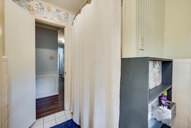 interior space with tile patterned flooring and tile walls