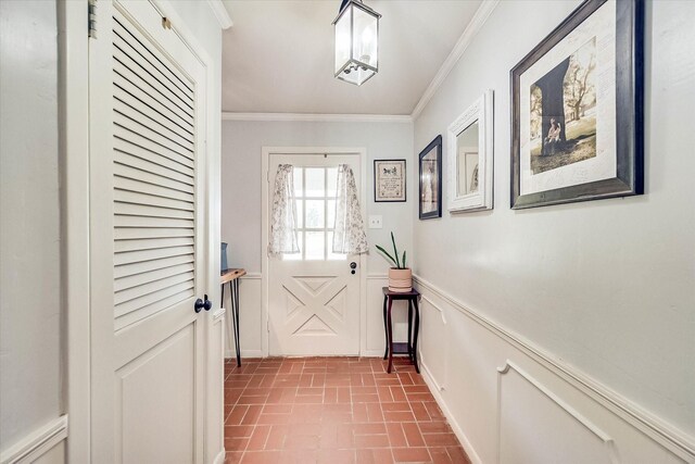 2225 W Park Ave, Corsicana, TX 75110 - doorway with brick patterned floors, ornamental molding, and a wainscoted wall