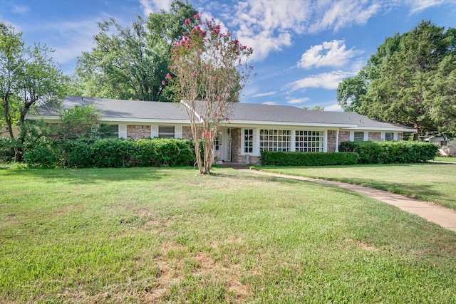 ranch-style house with a front lawn