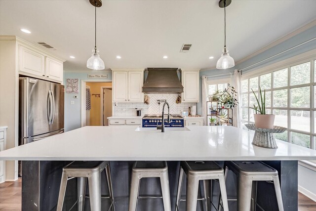 2225 W Park Ave, Corsicana, TX 75110 - kitchen featuring custom exhaust hood, backsplash, recessed lighting, light countertops, and a large island