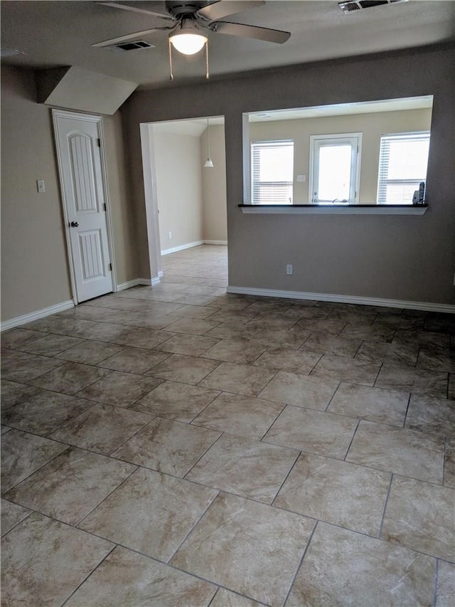 unfurnished room featuring ceiling fan and a healthy amount of sunlight