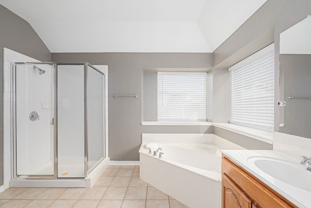 bathroom with independent shower and bath, vanity, tile patterned floors, and lofted ceiling